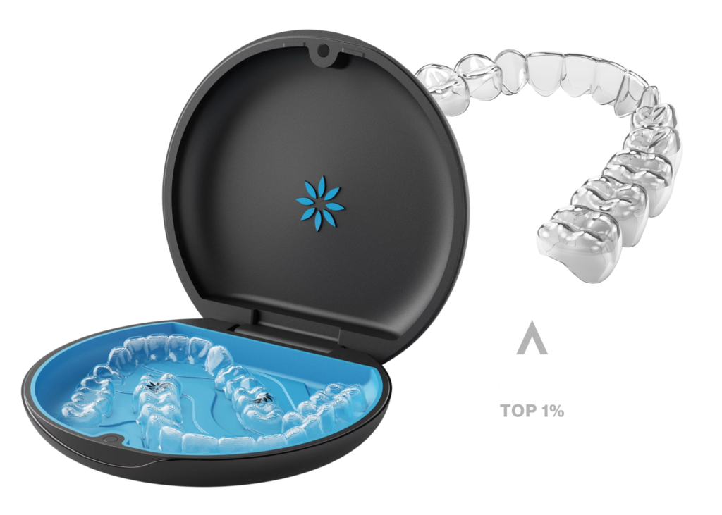 A clear dental aligner is displayed emerging from a black circular case with a blue interior. The background is white, conveying a clean, modern look.